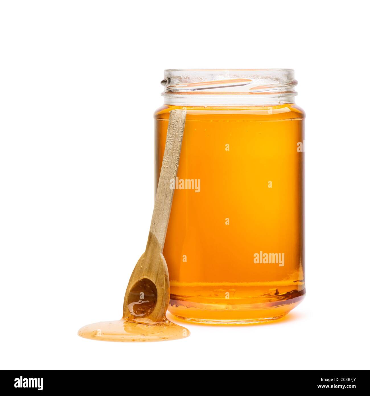 Honey jar with wooden dripping spoon, on white background Stock Photo