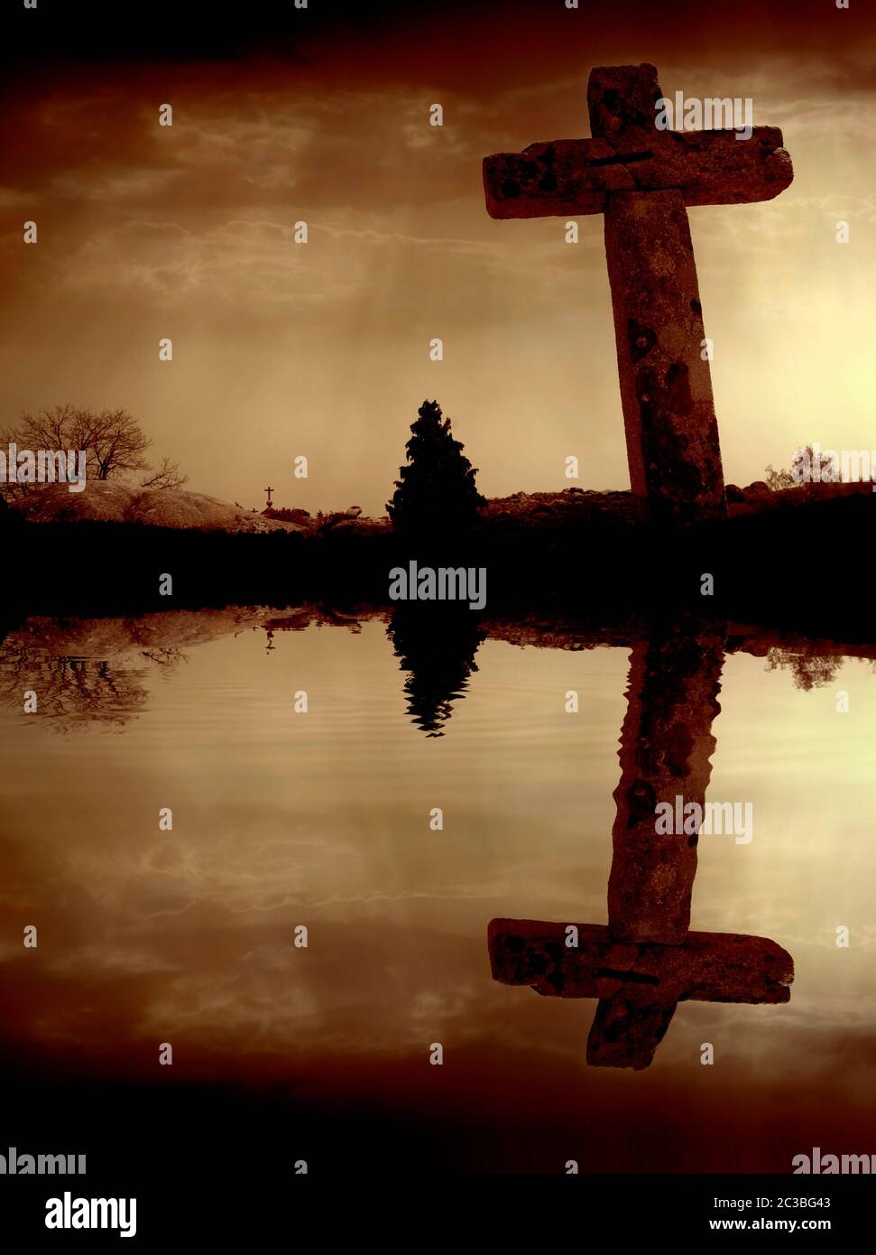 Christian cross and the clouds with water reflection Stock Photo