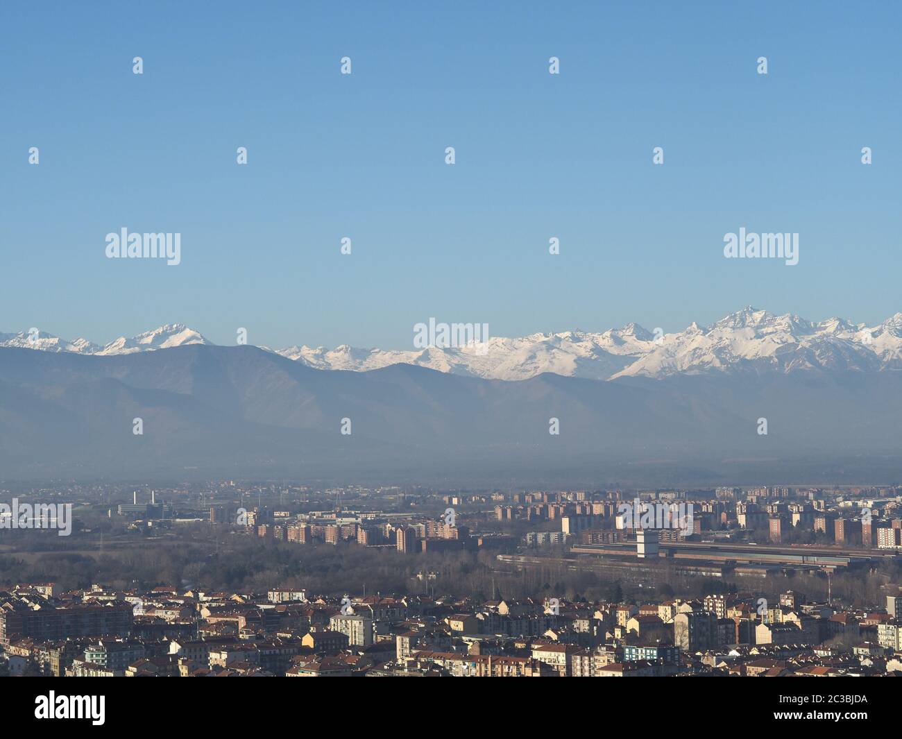 Aerial view of the city of Turin, Italy with Alps mountain range in the ...