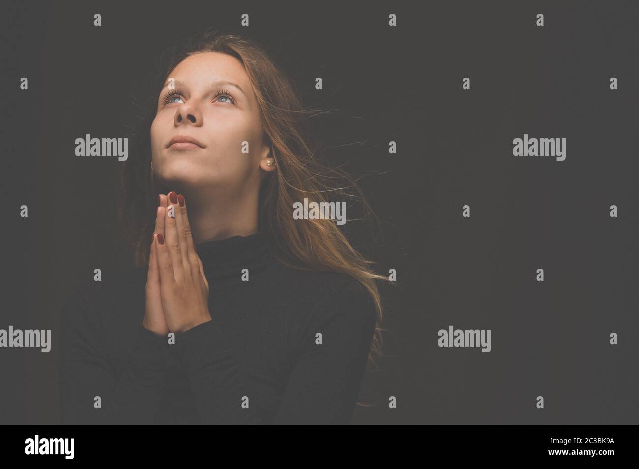 Young woman praying  to God. Christian life crisis prayer to god. Stock Photo