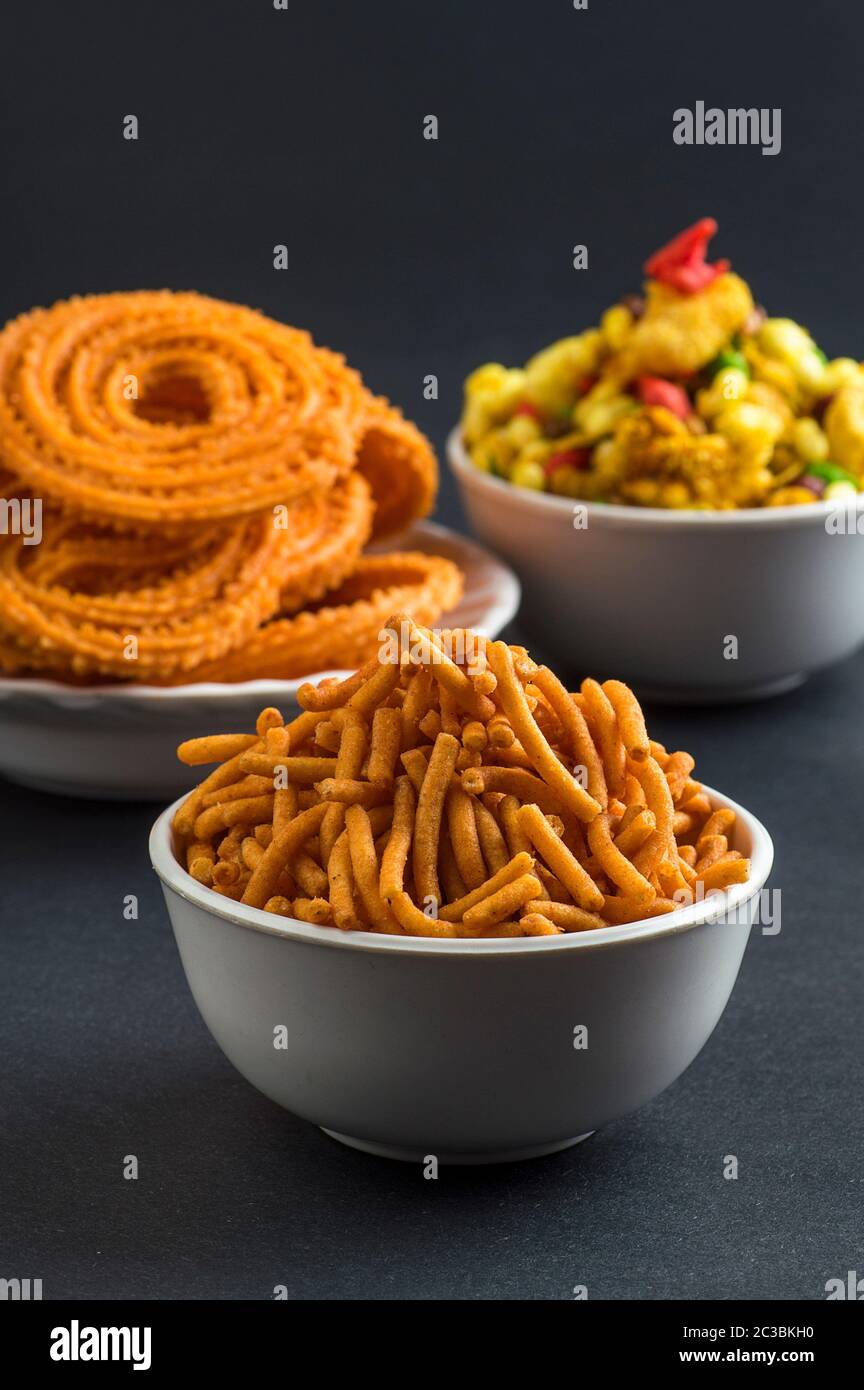 Indian Snack : Chakli, chakali or Murukku and Besan (Gram flour) Sev and chivada or chiwada. Diwali Food Stock Photo