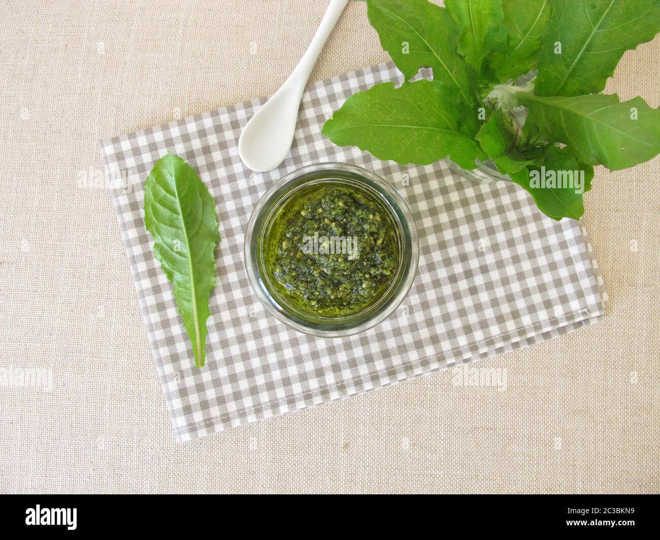 Green herbs pesto with dandelion leaves Stock Photo