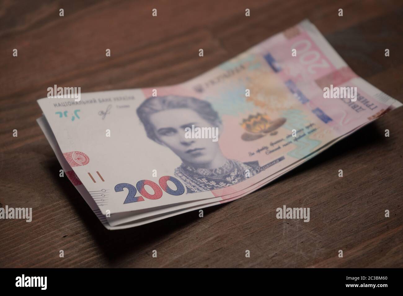 Bundle of New two hundred hryvnia notes. Pack of new Ukrainian money, paper hryvnias. Selective focus on number 200 in foreground. Cash concept Stock Photo