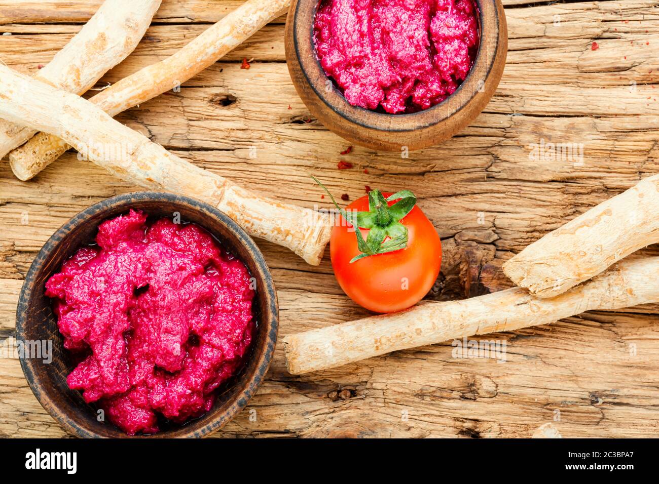Homemade spicy horseradish seasoning sauce on wooden table.Fresh grated