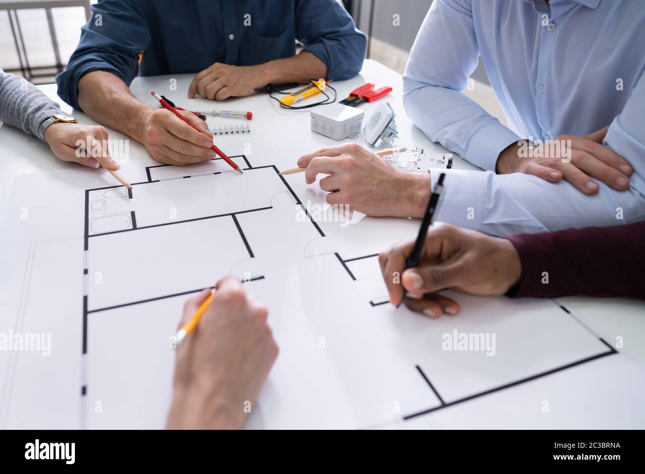 Elevated View Of An Architects Drawing Plan On Blueprint With Electrical Components Stock Photo