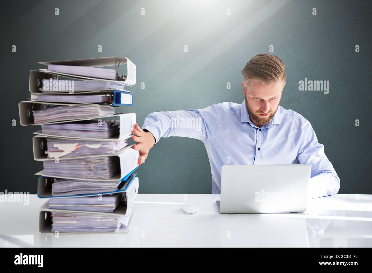 Businessperson Pushing Paper Documents Away And Working With Digital Documents On Computer Instead Stock Photo