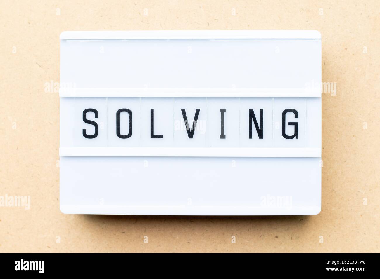 White lightbox with word solving on wood background Stock Photo