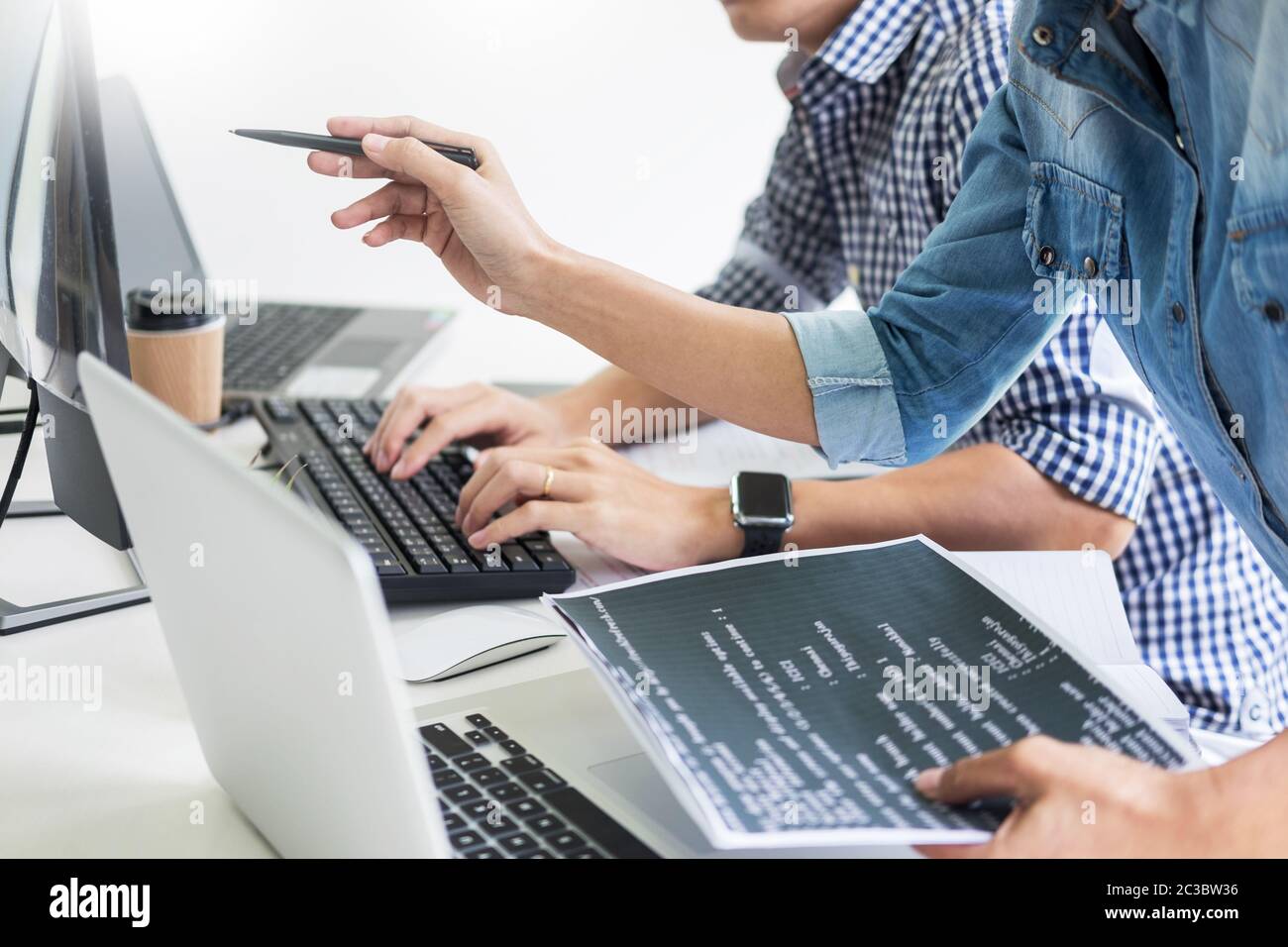 Asian team Outsource Developer Looking Screen Programming Code Working with Laptop Computer Software Stock Photo