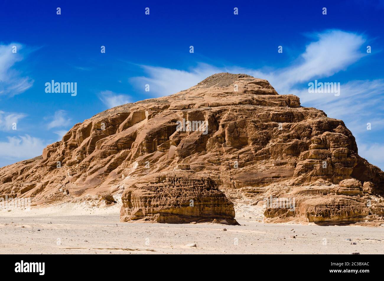 high rocky mountains against the blue sky and white clouds in the desert in Egypt Dahab South Sinai Stock Photo