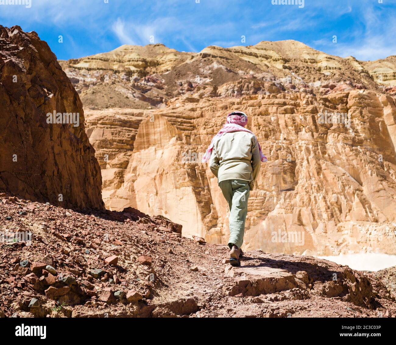 Bedouin climbs a mountain in a canyon in Egypt Dahab South Sinai Stock Photo
