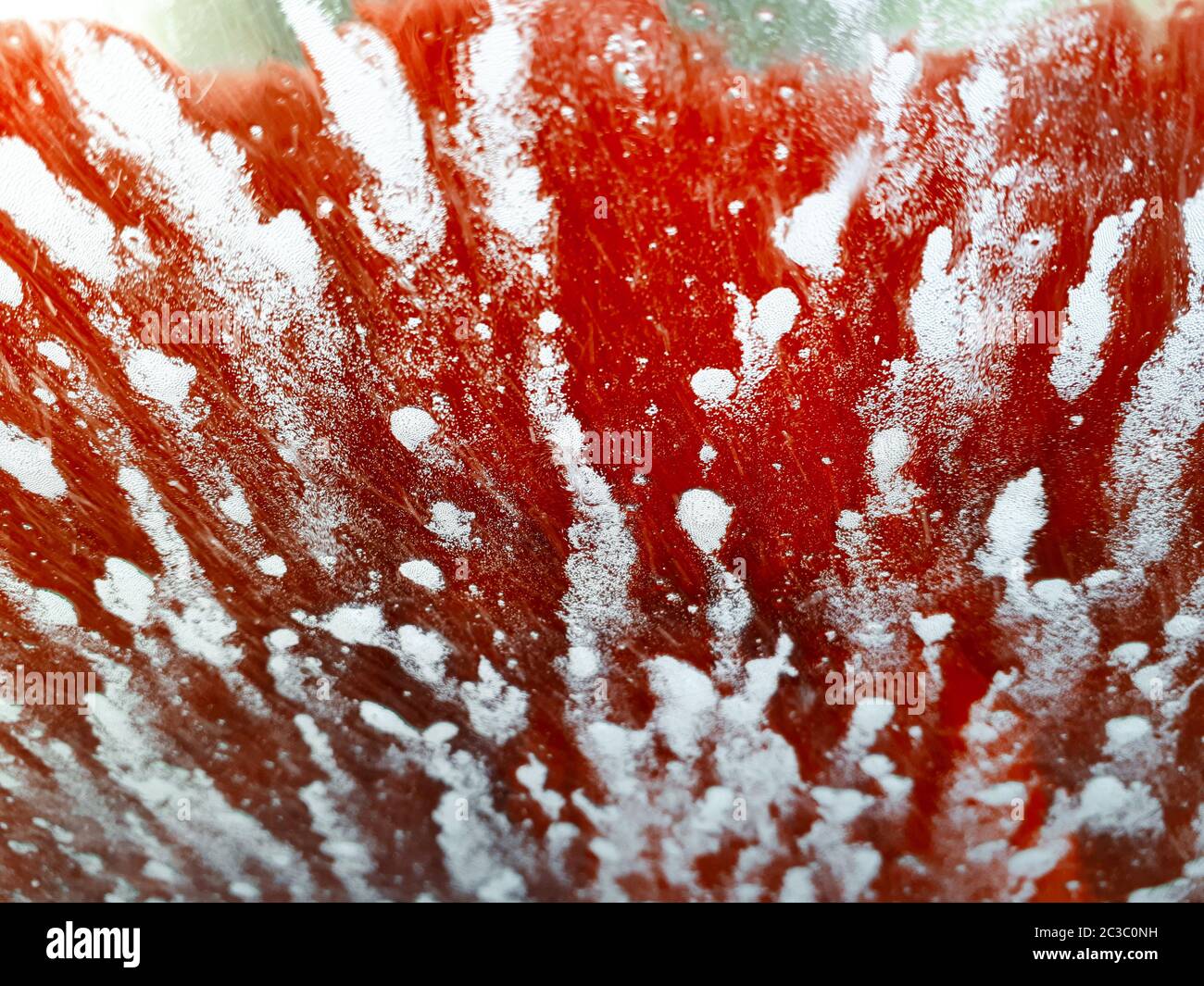 Artistic abstract patterns made on a windscreen whilst car is in a car wash Stock Photo