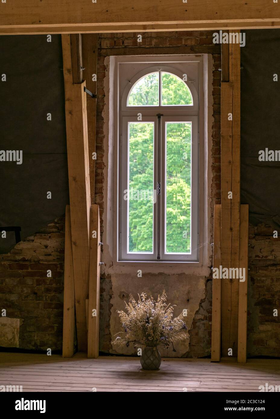 picture with wooden beams and windows in the roof attic, view out the ...