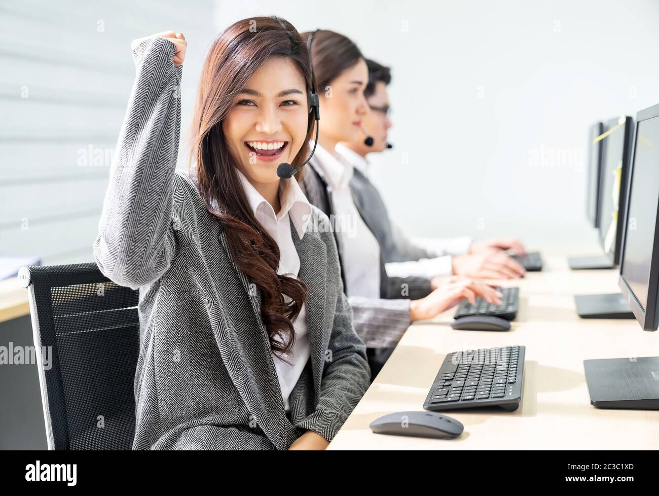 Smiling call Center working Stock Photo