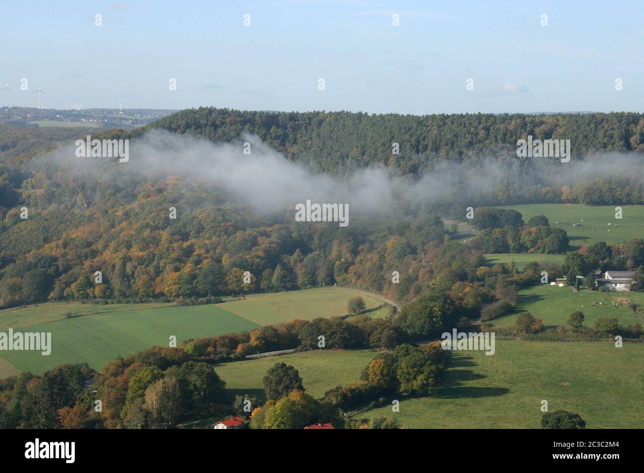 A wooded mountain range with fog Stock Photo