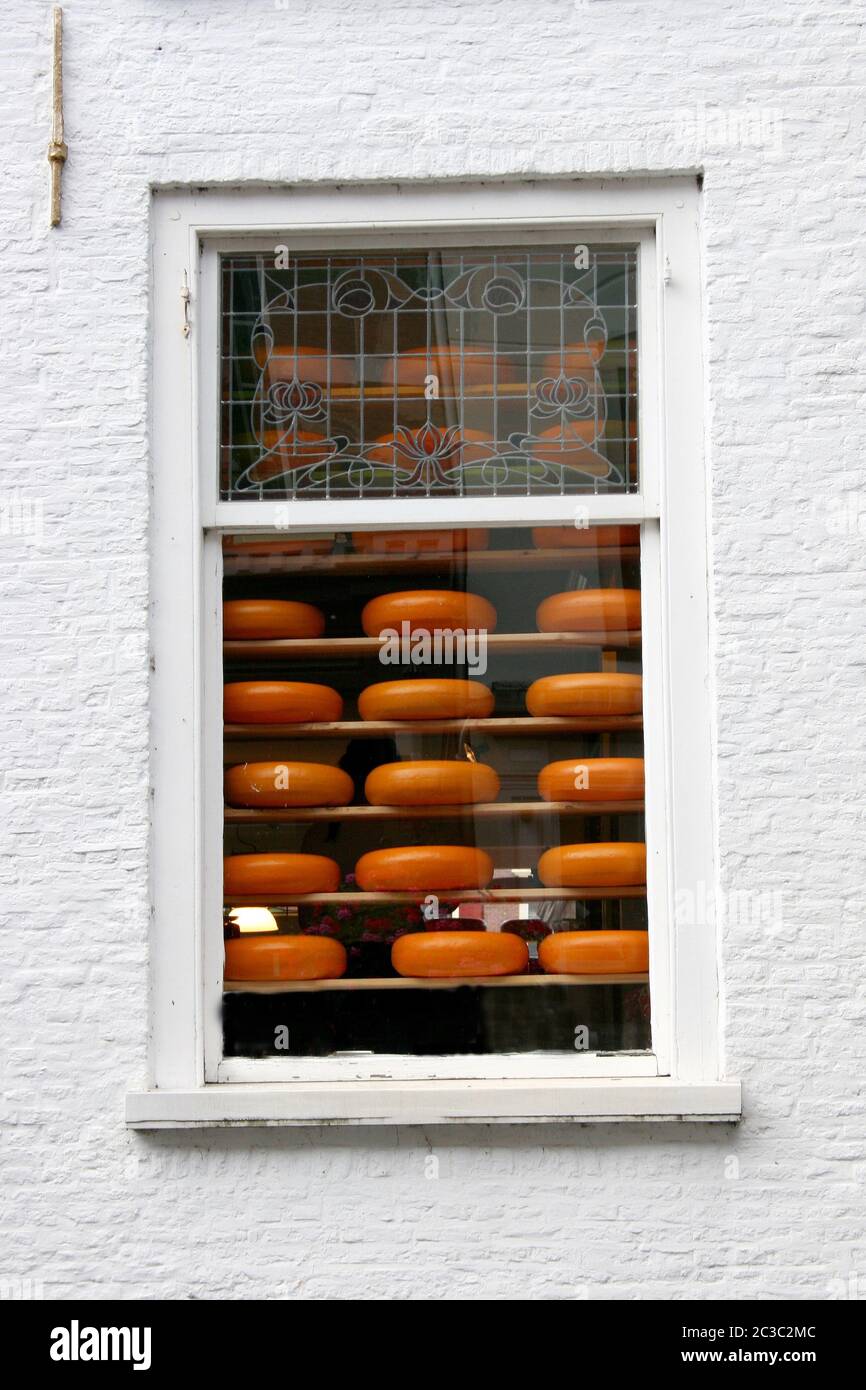 A window with cheeses for sale Stock Photo