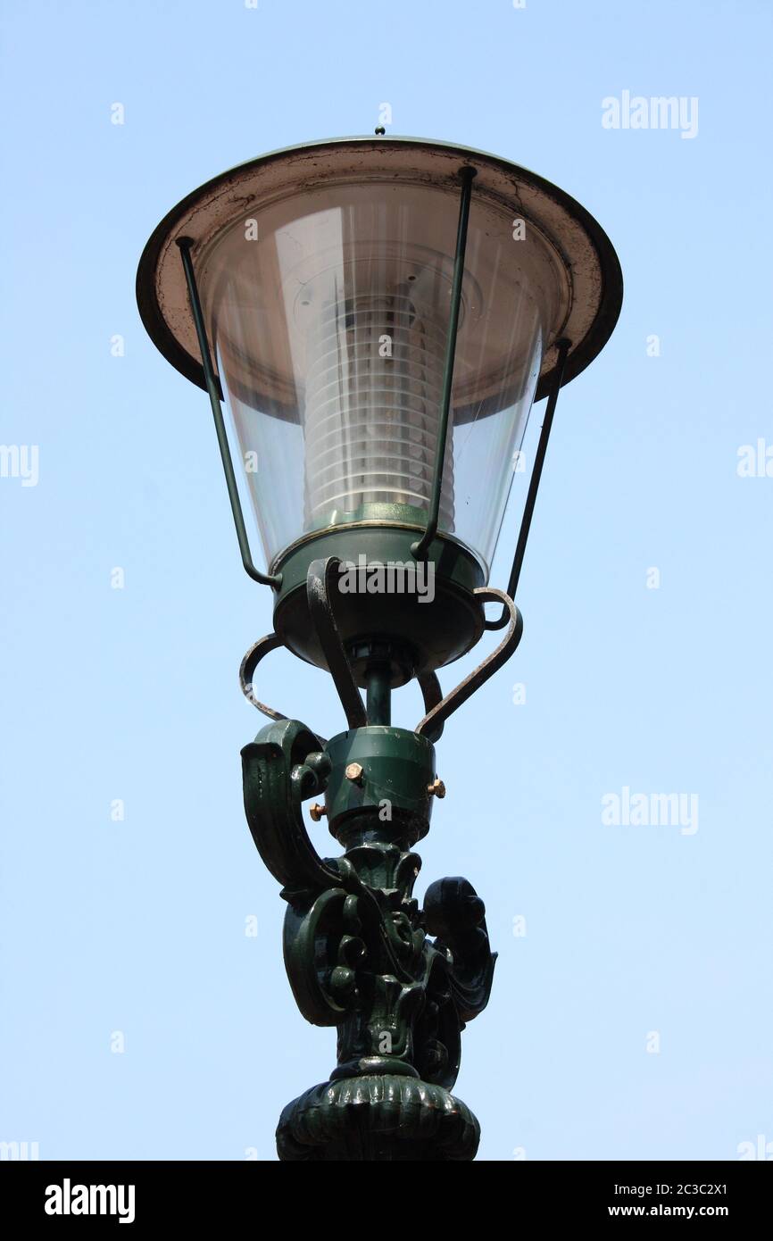 A decorated street lamp, blue sky in the background Stock Photo