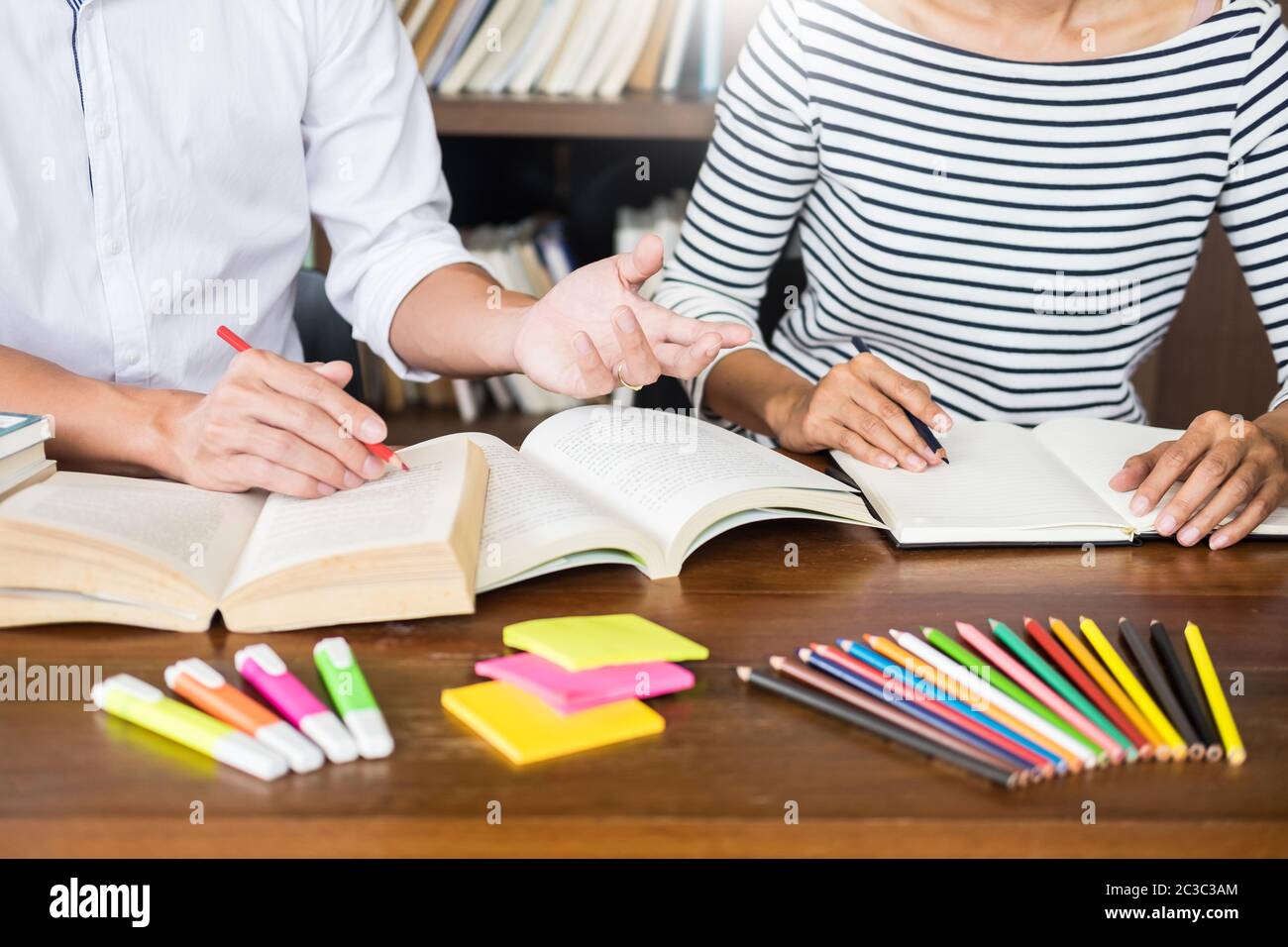 Students writing in textbooks class hi-res stock photography and images ...
