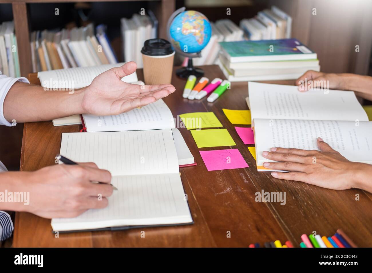Students writing in textbooks class hi-res stock photography and images ...