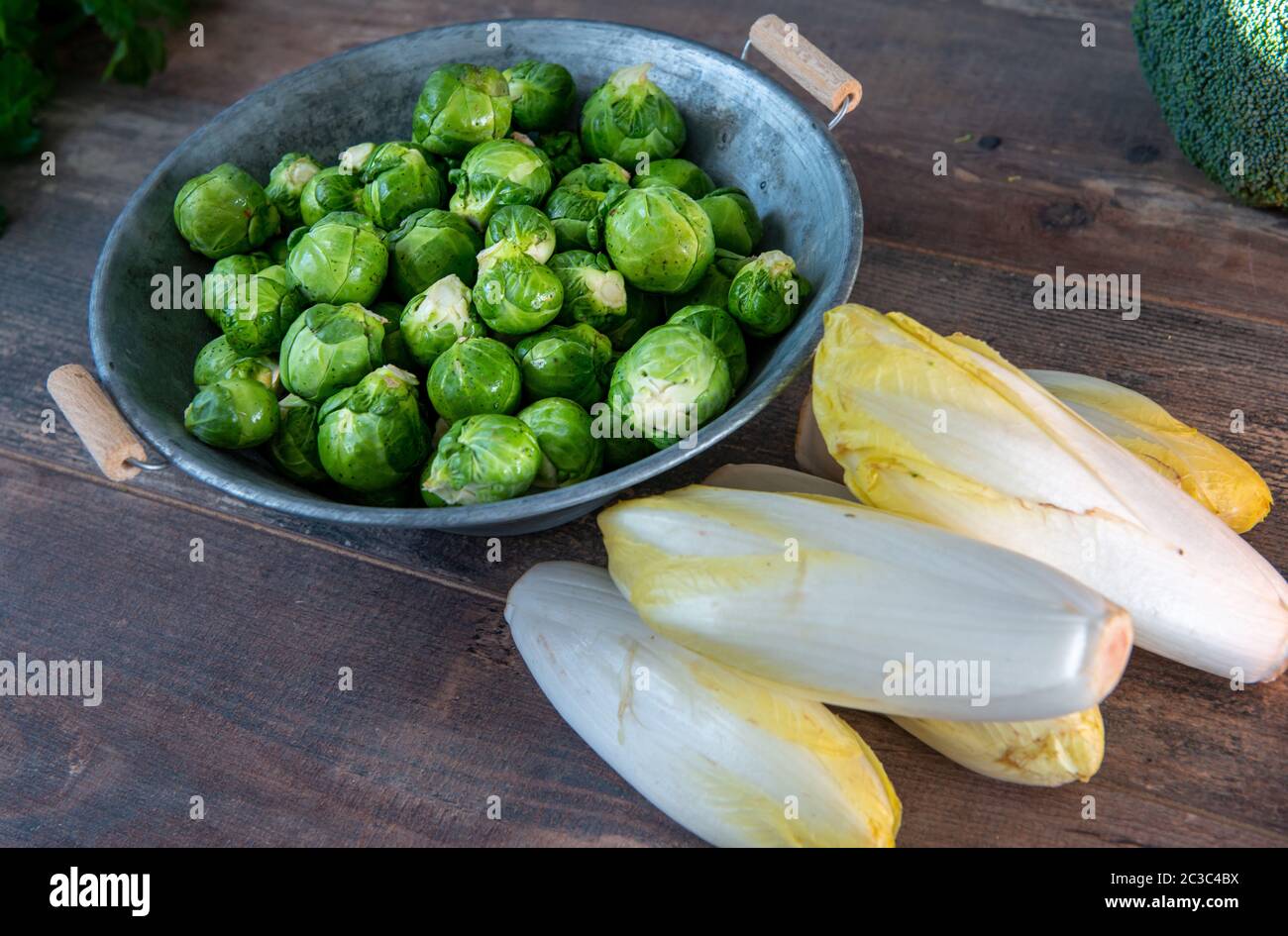sprouts and endives on a wooden background, Belgian vegetables Stock Photo