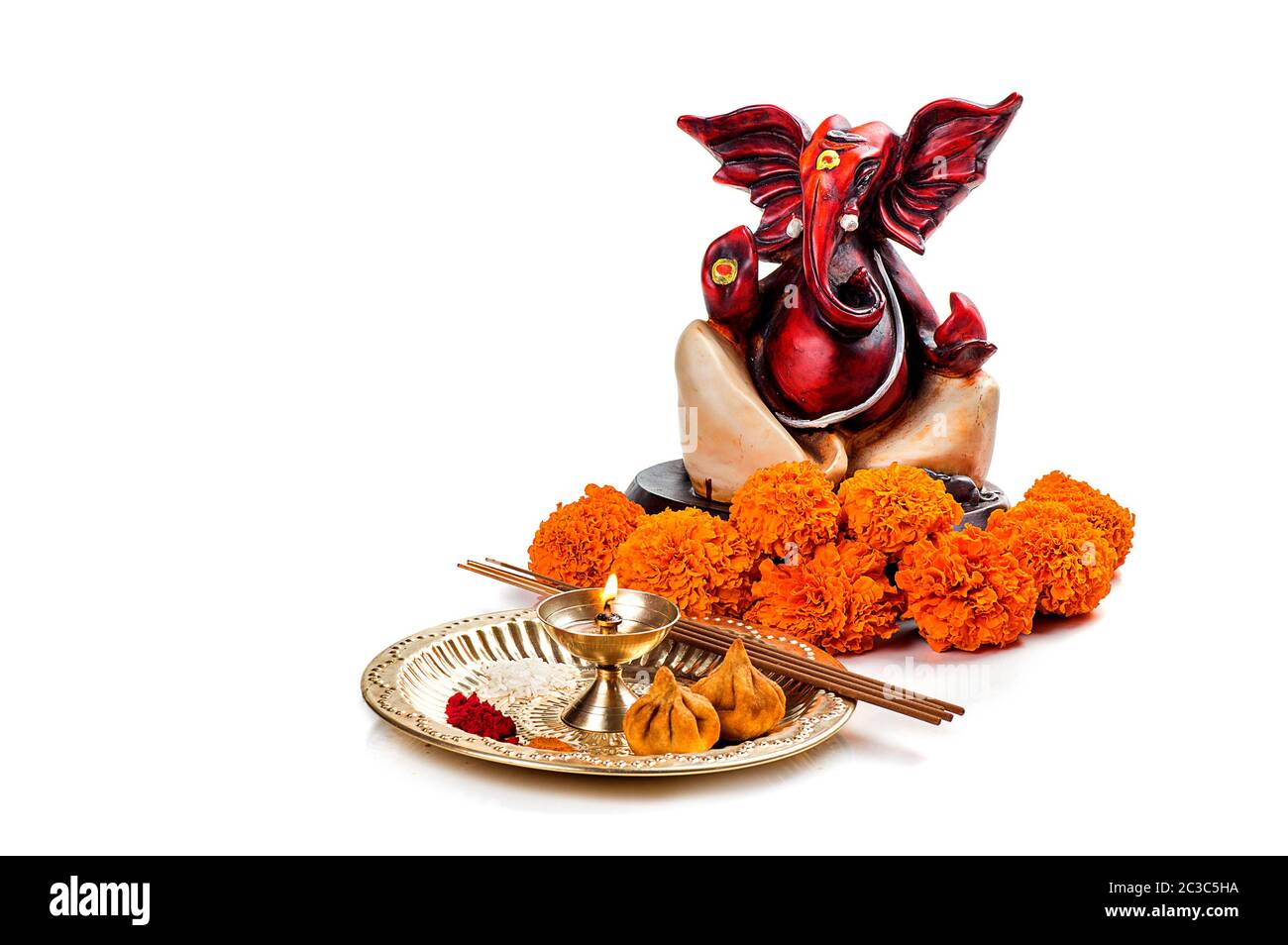 Hindu God Ganesha. Statue of Lord Ganesha. Worship (Pooja) arrangement on white background Stock