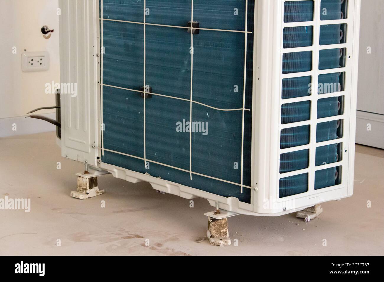 Residential air conditioner condenser unit inside a house Stock Photo