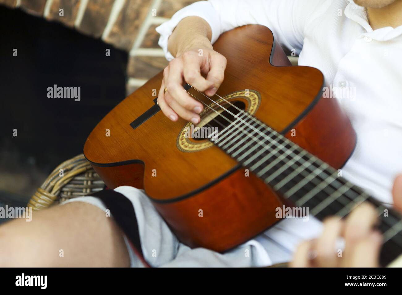 Crop man playing acoustic guitar Stock Photo