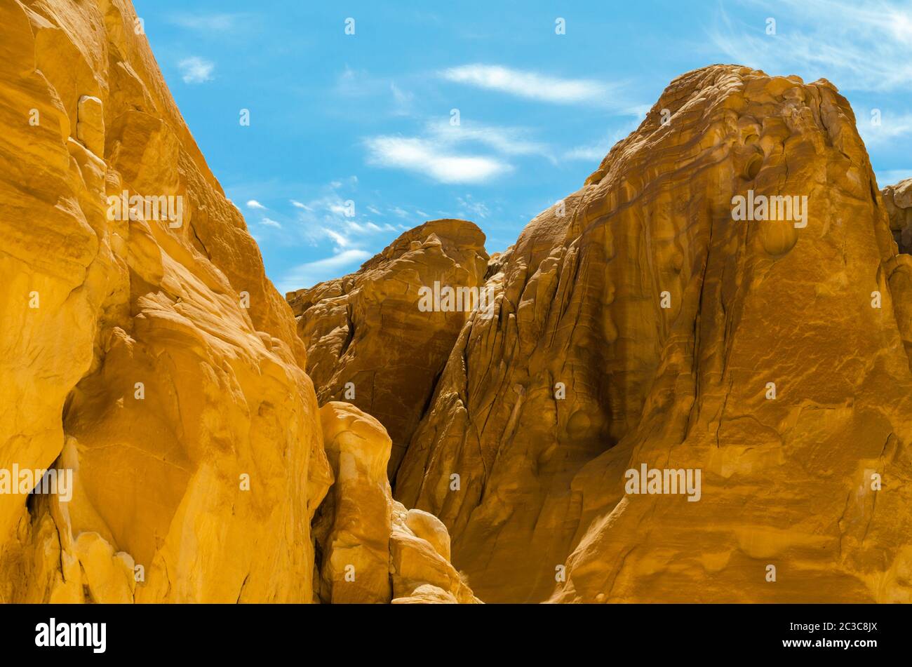 high rocky mountains against the blue sky and white clouds in the desert in Egypt Dahab South Sinai Stock Photo