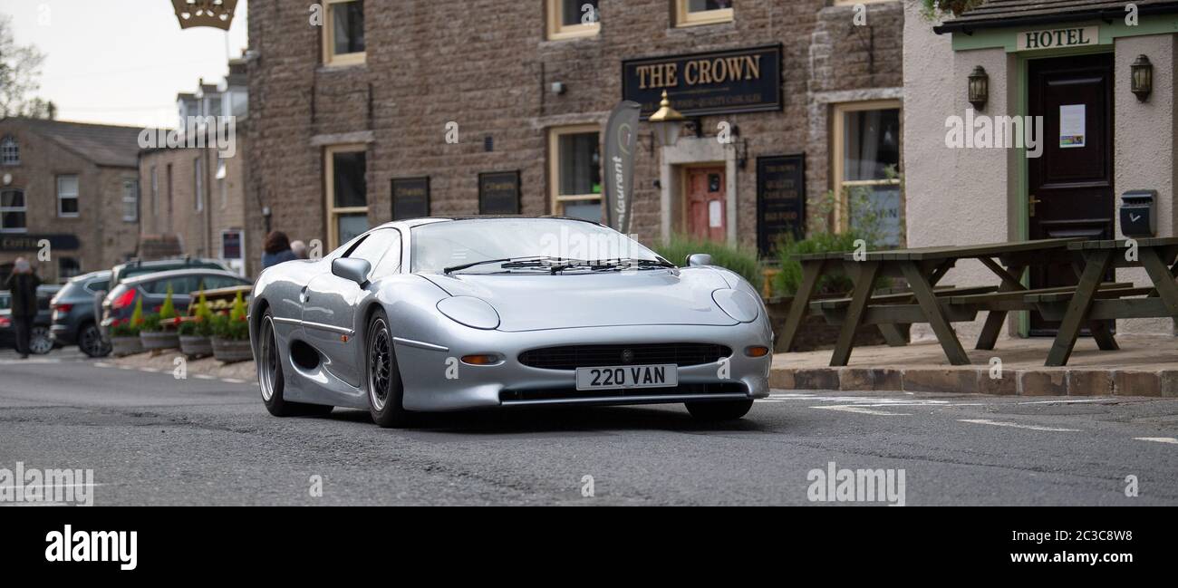 Supercars passing through the market town of Hawes in the Yorkshire Dales, UK, being filmed for the BBC Top Gear television program. UK Stock Photo