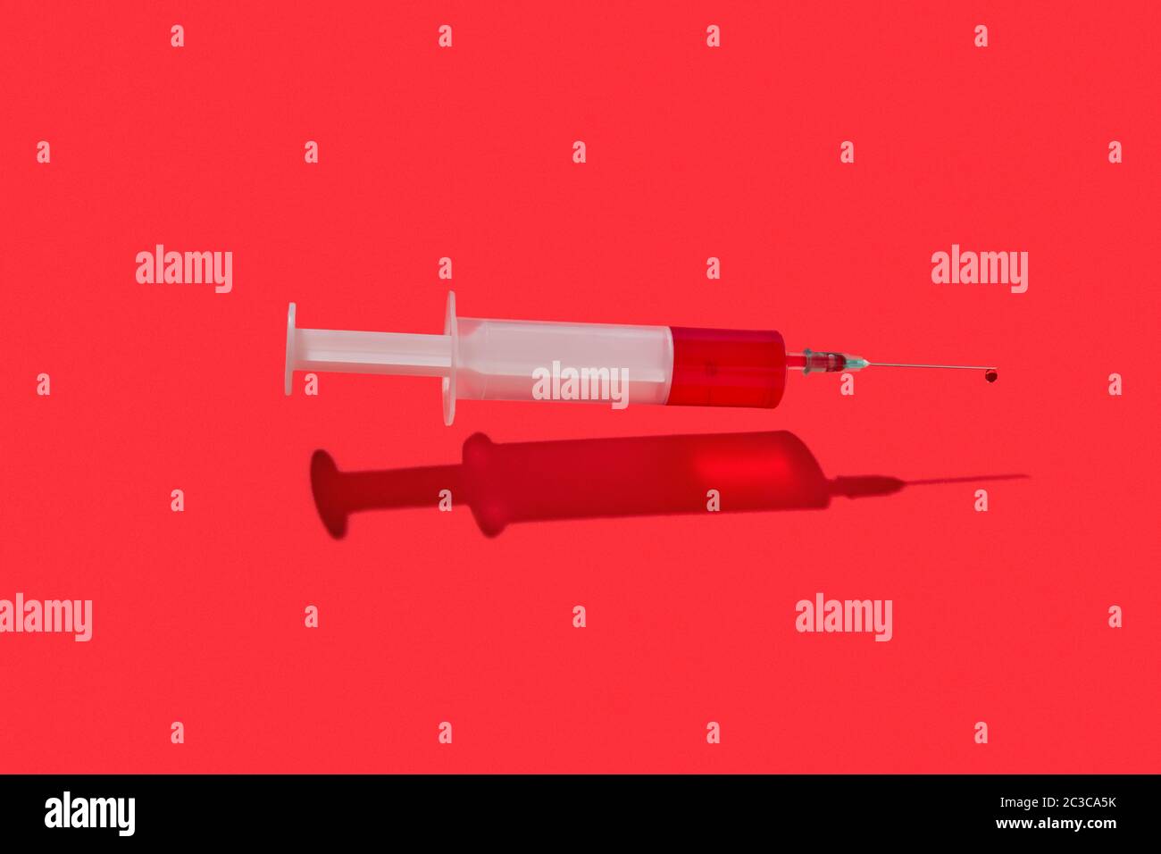 Flying syringe of red blood or liquid with drop on a needle Stock Photo ...