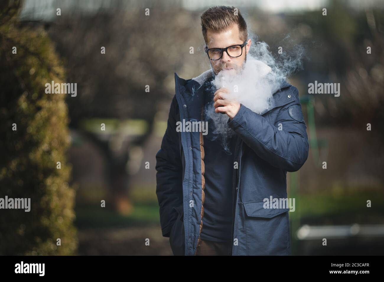 Vaping flavored e-liquid from an electronic cigarette Stock Photo