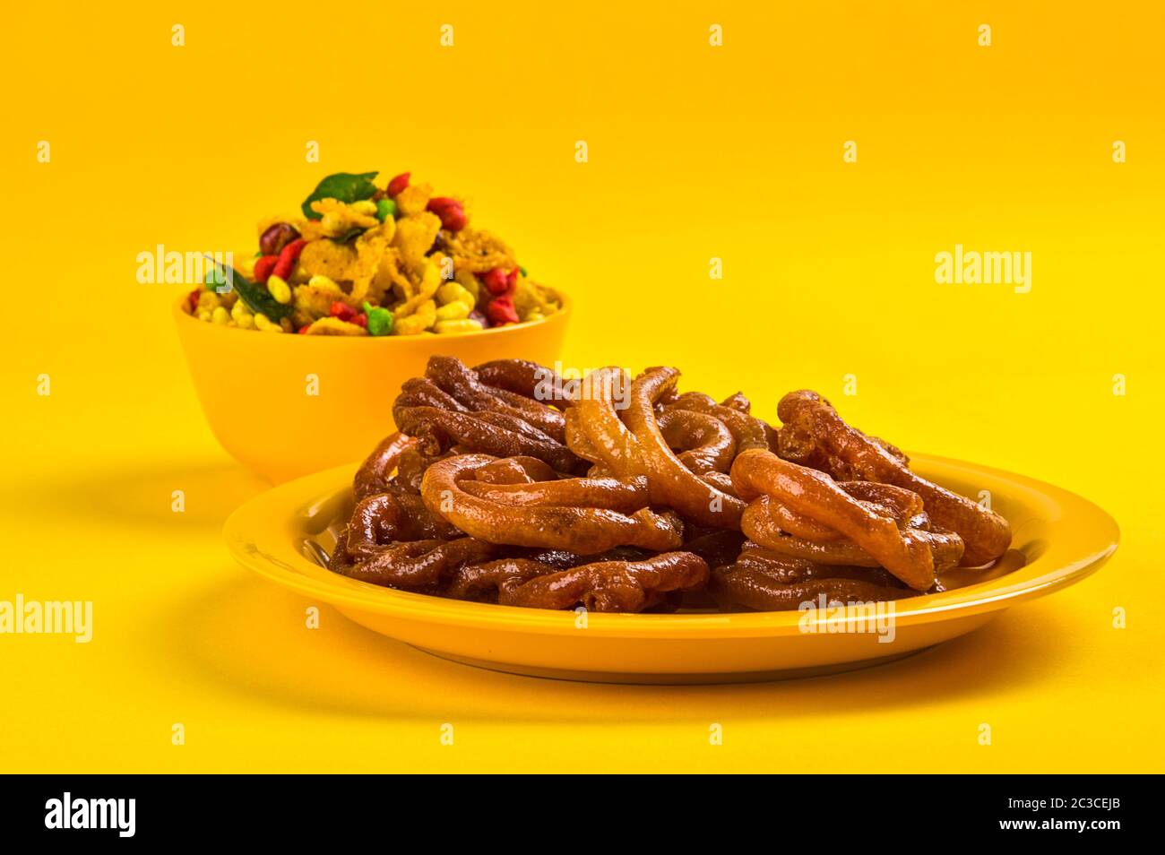 Jalebi and Traditional Indian deep fried salty dish called chivda or mixture or farsan Stock Photo