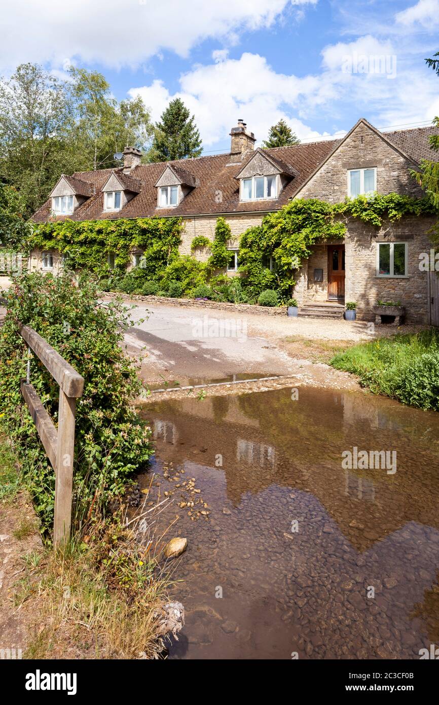 Cottages beside the ford in the Cotswold village of Duntisbourne Rouse, Gloucestershire UK Stock Photo