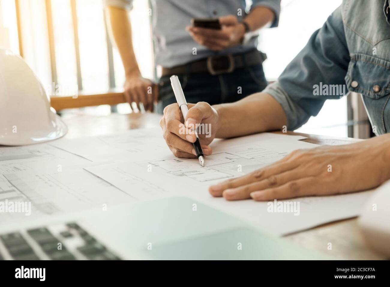 Engineer of architect starting draw a house blueprint on the desk in the office at construction working site and Engineering tools. Stock Photo