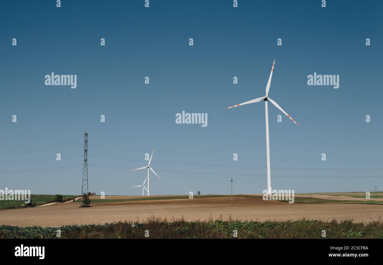 landscape with empty fields and wind turbines over clear blue sky Stock ...