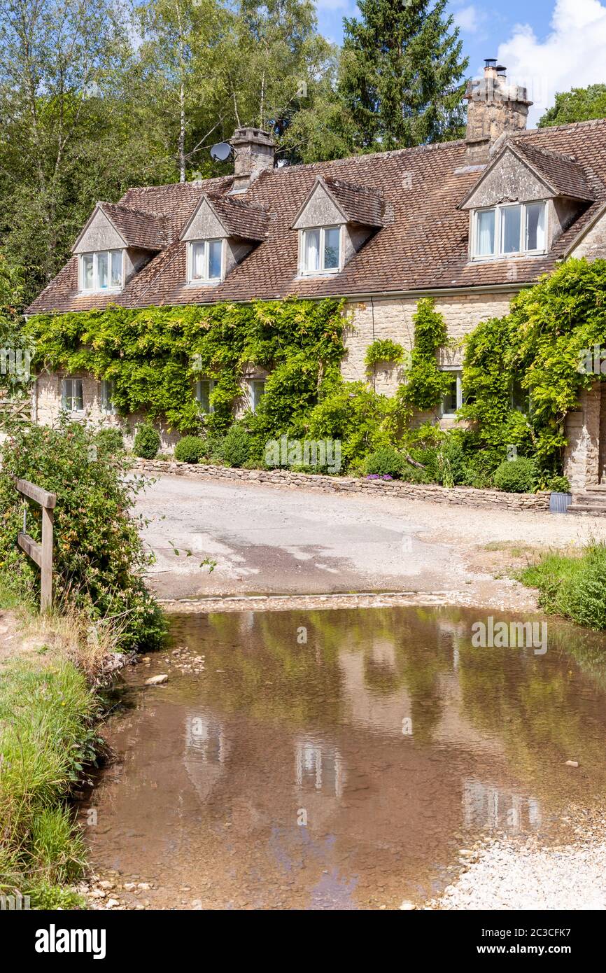 Cottages beside the ford in the Cotswold village of Duntisbourne Rouse, Gloucestershire UK Stock Photo