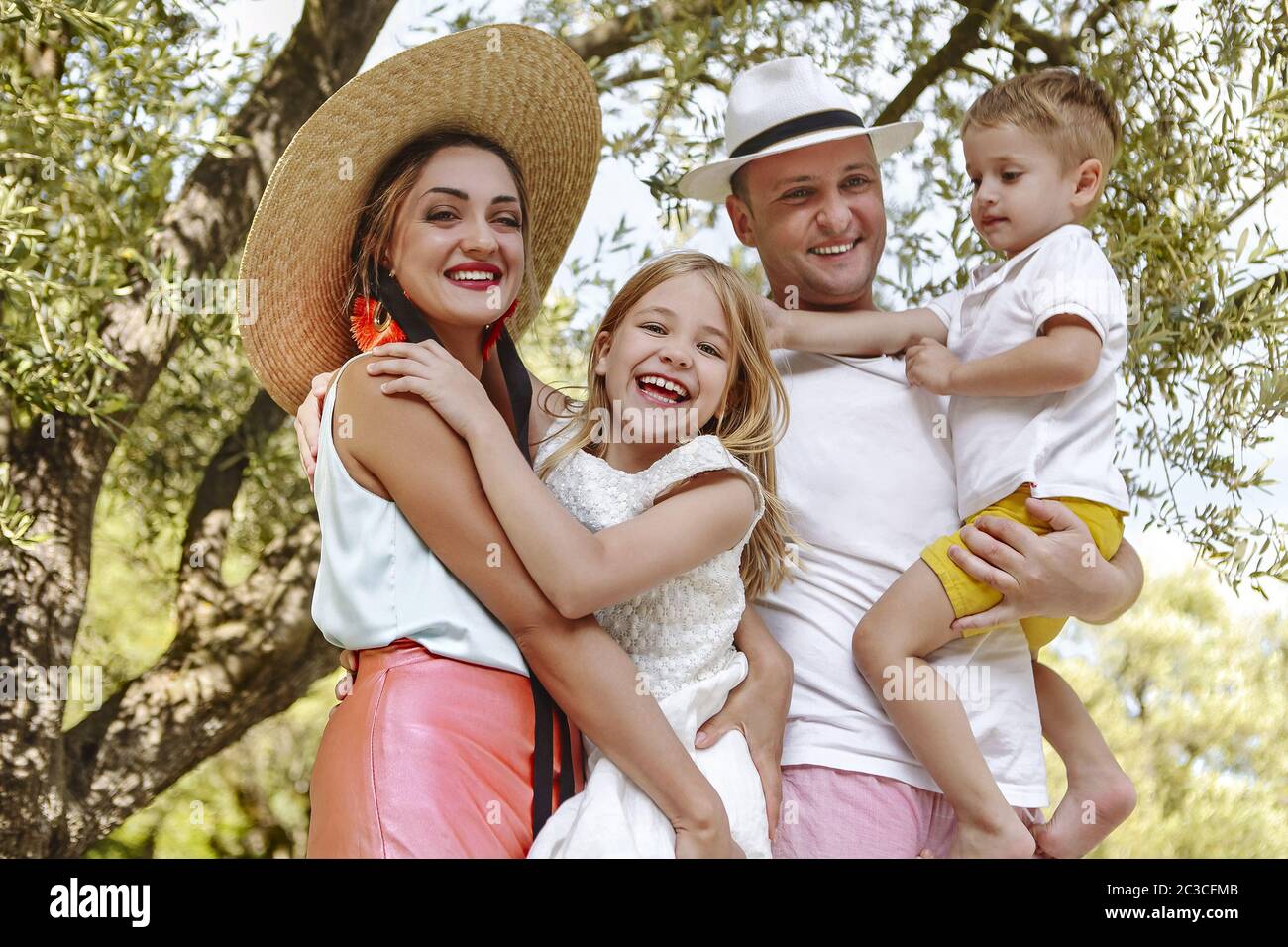 Happy young family on summer holiday Stock Photo - Alamy