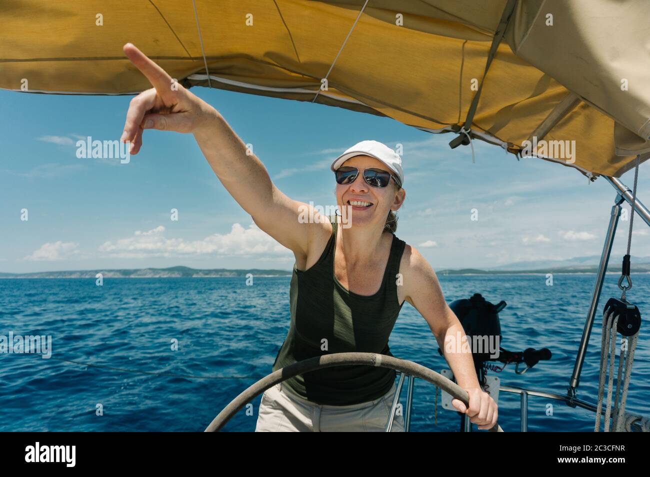 Female skipper on the steering wheel of a yacht. Sailing and yachting concept Stock Photo Alamy