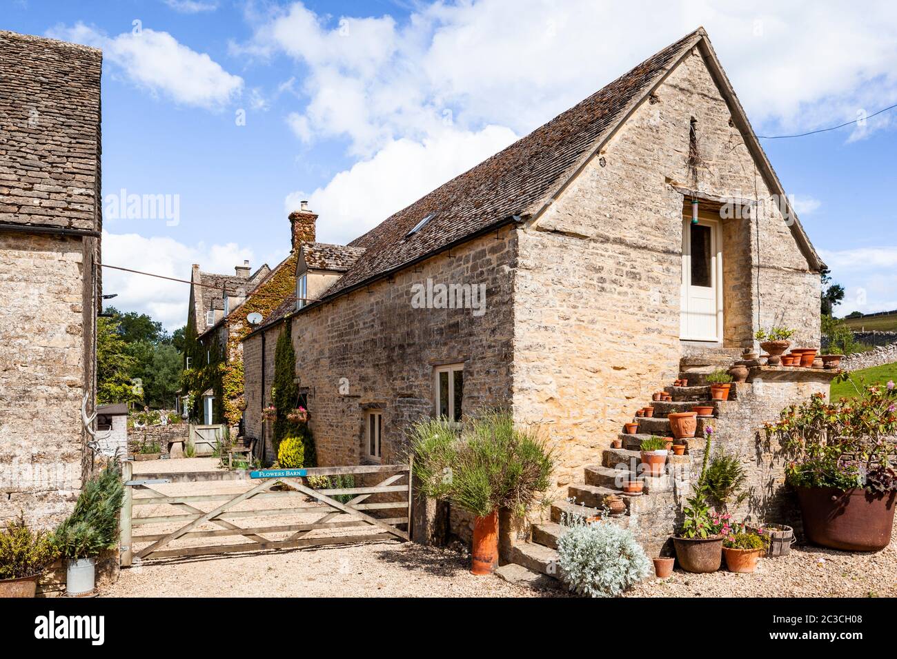 Flowers Barn alongside 17th century Manor Farm in the Cotswold village of Middle Duntisbourne, Gloucestershire UK Stock Photo