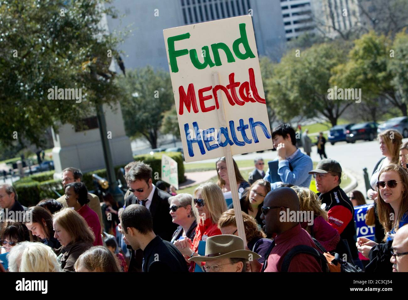 Crowd attends rally and holds up signs asking the Texas legislature for additional funding for mental health services. ©MKC/Bob Daemmrich Photography, Inc. Stock Photo