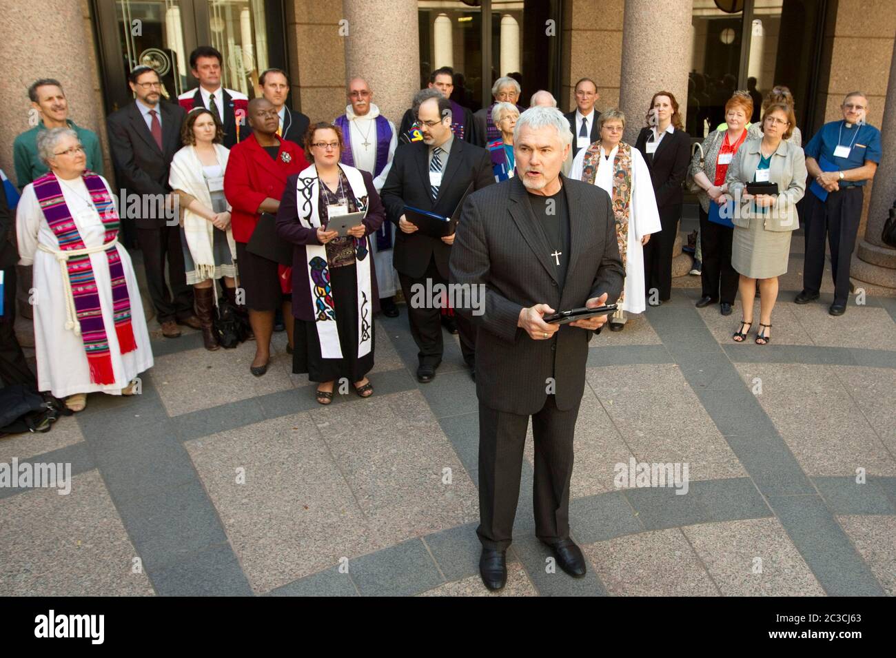 Austin, Texas USA, February 2013: White male minister, backed by other clergy members, urges Texas legislators to restore funding for family planning and birth-control services for low-income women during a press conference at the Texas Capitol. Texas Faith in Action and the Texas Freedom Network are nonpartisan, grassroots organization of religious and community leaders. ©MKC/Bob Daemmrich Photography, Inc. Stock Photo