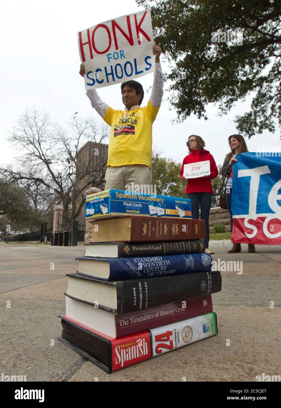 Hispanic male stands in front of stack of textbooks and  holds up sign asking for support prior to a pro-education rally at the Texas Capitol building in Austin, Texas, during the legislative session. ©MKC/Bob Daemmrich Photography, Inc. Stock Photo