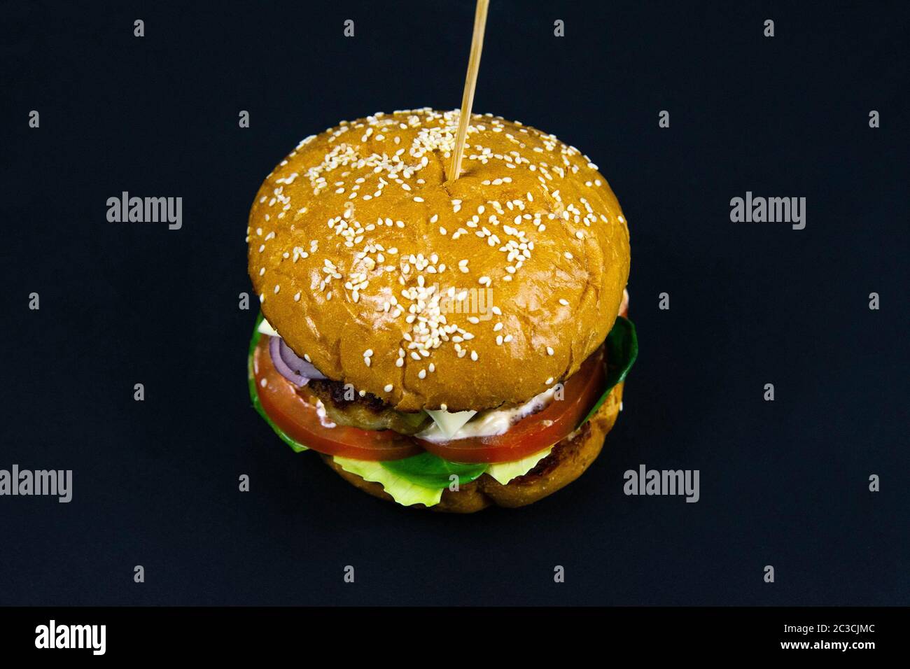 Fresh tasty burger on black background front views Stock Photo