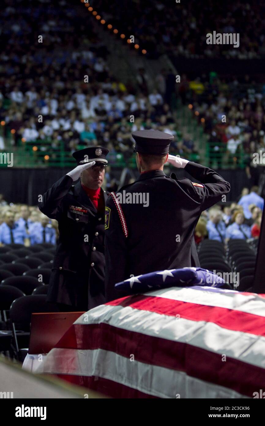 April 25, 2013 Waco, Texas USA: Honor guard members stand in front of flag-draped coffins as thousands of mourners attend a memorial for firefighters killed in the West, Texas, fertilizer plant explosion on April 17. Twelve of the 15 people killed were first responders.  ©Marjorie Kamys Cotera/Daemmrich Photography Stock Photo