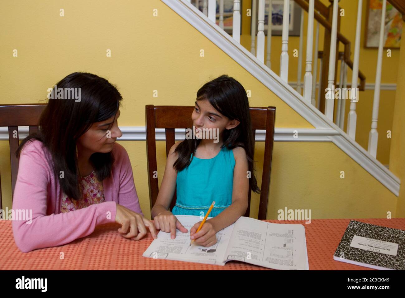 Austin Texas USA, 2012: Mexican mother helps her left-handed Mexican-American 10-year-old daughter with homework. ©Marjorie Kamys Cotera/Daemmrich Photography Stock Photo