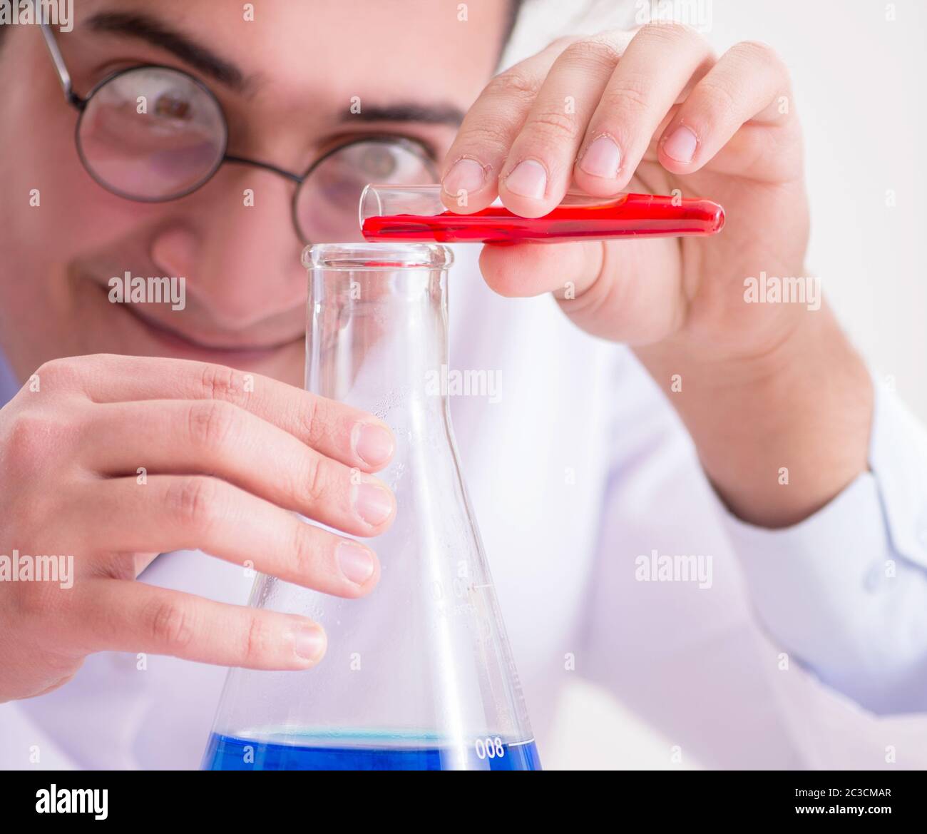 Mad crazy scientist doctor doing experiments in a laboratory Stock Photo