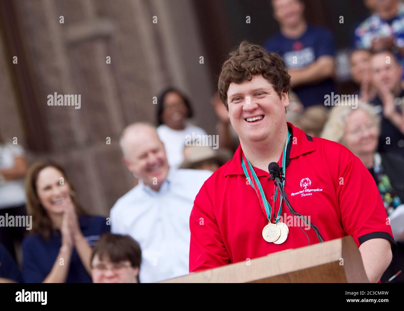Male teenage Special Olympian speaks at podium outside the Texas Capitol building before the lighting of the Special Olympics torch in Austin, Texas ©Marjorie Kamys Cotera/Daemmrich Photography Stock Photo