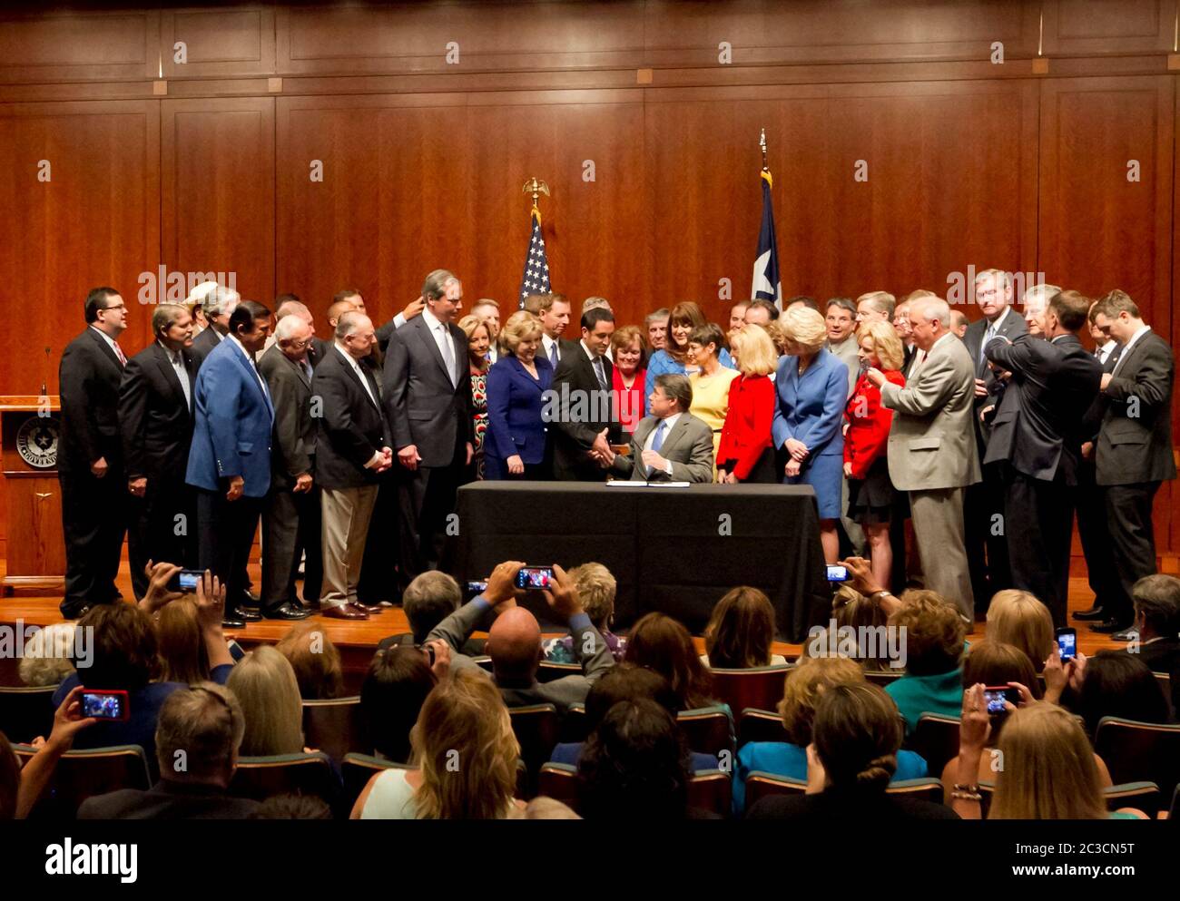 Austin, Texas USA, July 18, 2013: Texas Gov. Rick Perry signs controversial HB2, placing new restrictions on women's access to abortion, into law with a room full of mostly Republican Representatives and Senators including author Jodie Laubenberg R-Murphy and co-author Sen. Glen Hegar R-Katy. On stage also was Sen. Eddie Lucio D-Brownsville, the only Democratic senator in favor of the bill. ©Marjorie Kamys Cotera/Daemmrich Photography Stock Photo