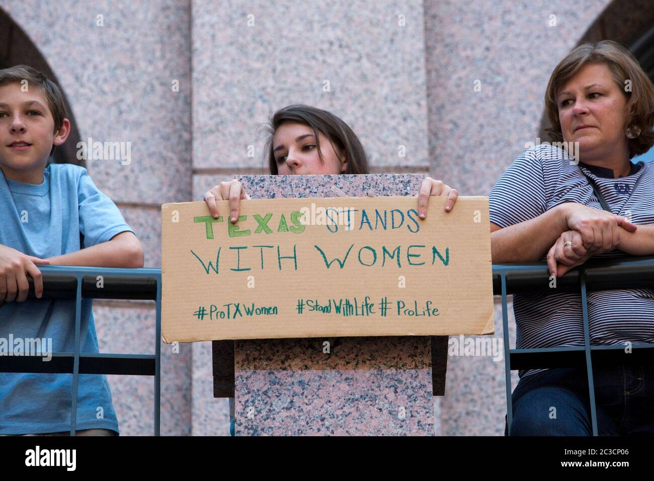 July 2, 2013 Austin, Texas USA: During competing rallies at the Texas Capitol, a young woman holds a hand-made sign opposing abortion and supporting anti-abortion legislation as the House Committee on State Affairs holds hearings on a controversial abortion bill. ©MKC/Bob Daemmrich Photography, Inc. Stock Photo