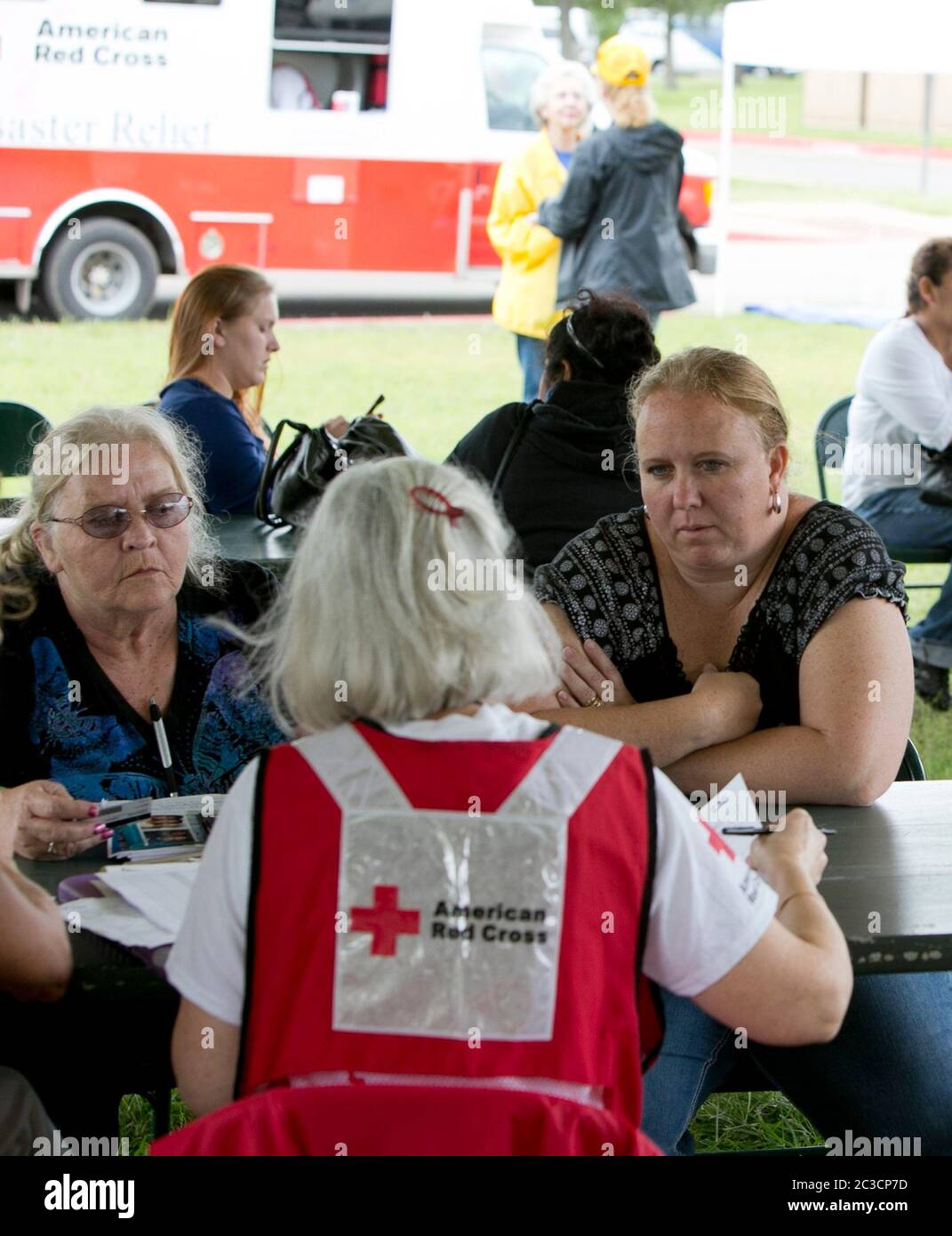 Austin, Texas USA, November 5, 2013: Volunteers from the American Red Cross help victims of a flash flood on Onion Creek. On October 31st, a deadly flash flood ripped though the area, leaving hundreds of homes damaged and several people dead. The group set up tents, tables and chairs where volunteers helped connect victims to various forms of assistance. ©Marjorie Kamys Cotera/Daemmrich Stock Photo
