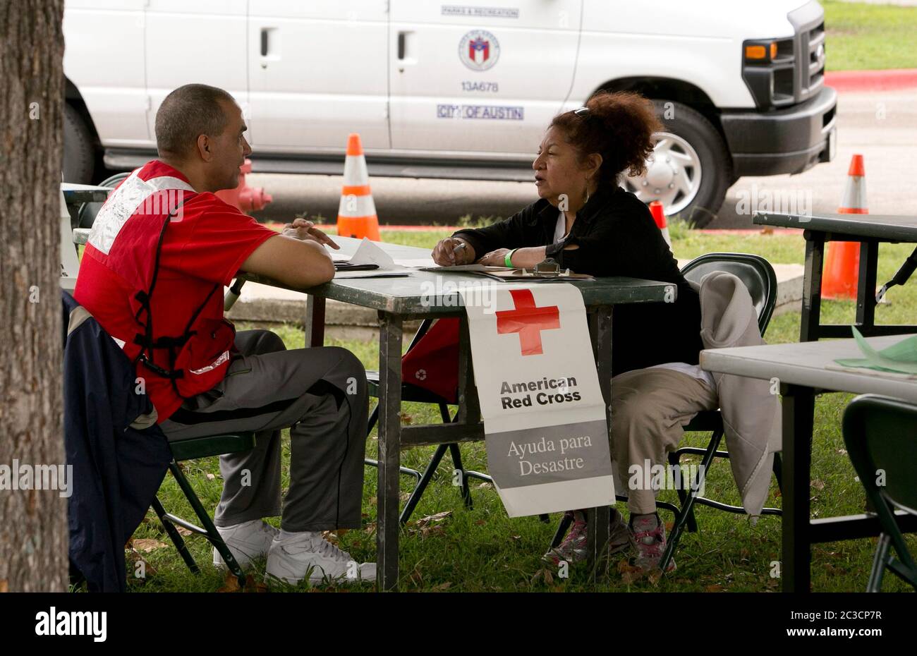Austin, Texas USA, November 5, 2013: Volunteers from the American Red Cross help victims of a flash flood on Onion Creek. On October 31st, a deadly flash flood ripped though the area, leaving hundreds of homes damaged and several people dead. The group set up tents, tables and chairs where volunteers helped connect victims to various forms of assistance. ©Marjorie Kamys Cotera/Daemmrich Stock Photo